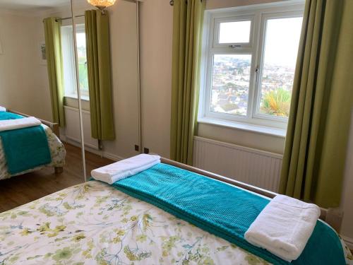 a bedroom with a large bed with a mirror at Paignton View Holiday Home in Paignton