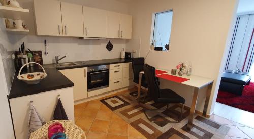 a small kitchen with a table and a counter top at Ferienwohnung Gartenblick mit Terrasse in Bad Abbach