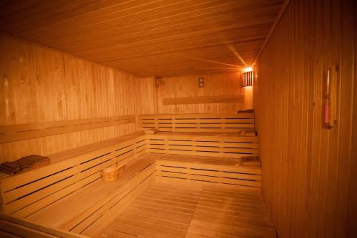 an empty wooden sauna with wooden floors and wooden walls at Grand Hotel & Convention Center Karaman in Karaman