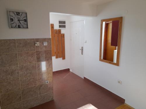 a bathroom with a shower and a mirror on the wall at Apartmani Nova Zova in Zlatibor