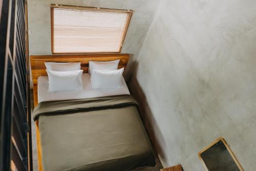 a small bed in a small room with a window at Country side room northern UBUD in Tegalalang