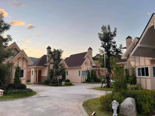 a large house with a driveway in front of it at The iNow ไอหนาว เขาค้อ in Khao Kho