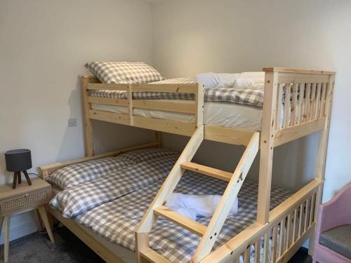 two wooden bunk beds in a room with at Stunning Hillside House in Langport