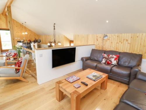 a living room with a couch and a table at The Meeting House in Sheepstor