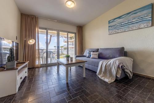 a living room with a couch and a table at Apartamentos DMS V Arysal in Cambrils