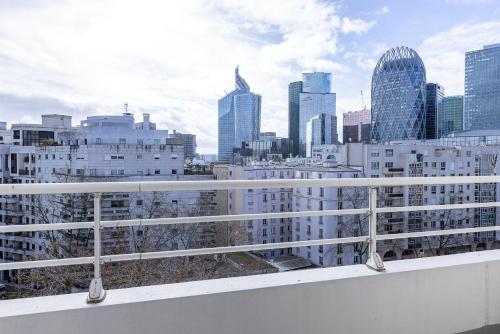 a view of a city skyline from a balcony at Star Of Life in Courbevoie