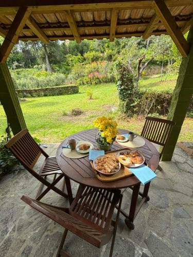 a wooden table with food on it on a patio at Casa Verde Country House in Montescudaio
