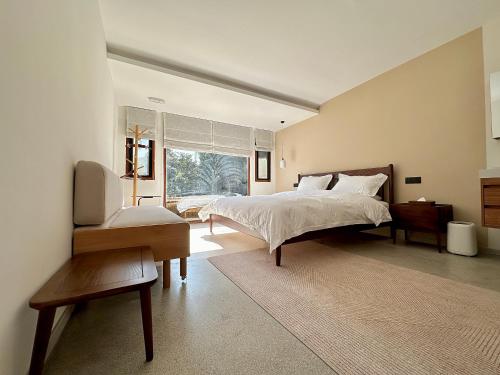a bedroom with a large bed and a window at Xianqingshan Homestay in Hangzhou