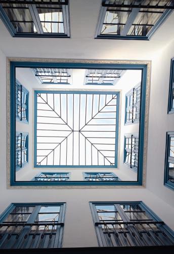 a large window in a room with threeadders at Casa Palacio Don Pedro in Seville