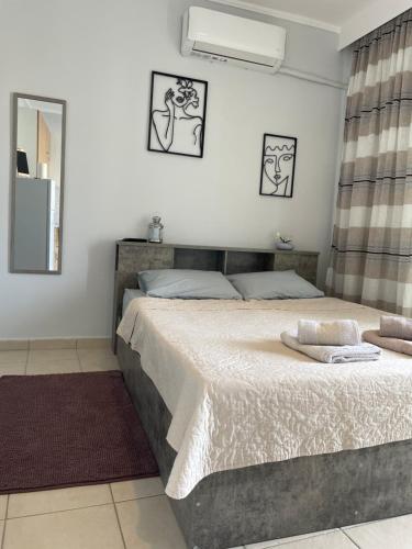 a bedroom with a large bed and a mirror at Kate's Studio with view in Serres