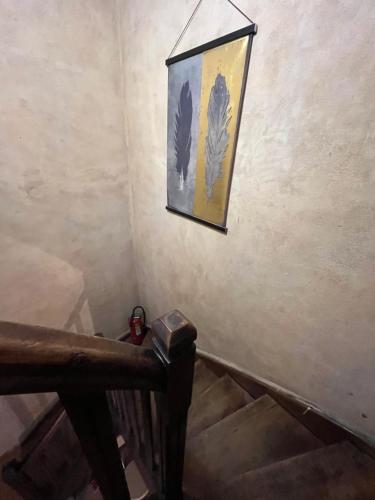 a picture hanging on a wall next to a staircase at Maison du Fenouillet in Saint-Gervais-sur-Roubion