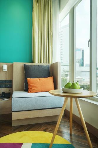 a living room with a couch and a table at SQ Boutique Hotel in Bangkok