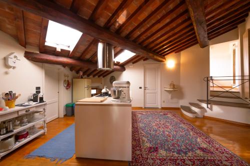a kitchen with an island in the middle of a room at Loft Elegance in Pistoia