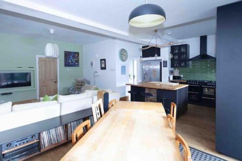 a kitchen and living room with a table and a couch at Seafront home with fabulous sea views in Herne Bay