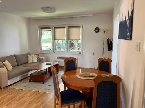 - un salon avec une table et un canapé dans l'établissement Timeless Sarajevo Apartment, à Sarajevo