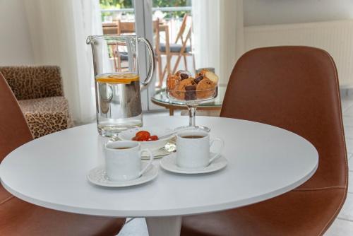 a white table with two cups and a blender on it at TheasHomly in Kastanéa