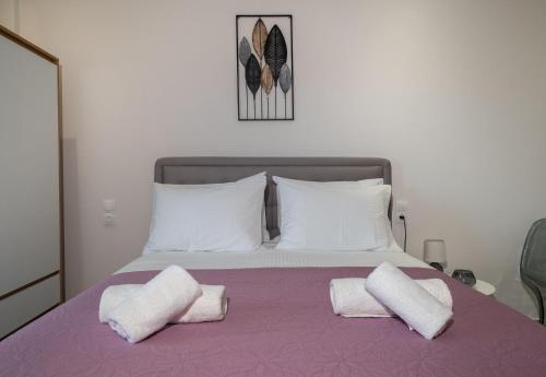 a bedroom with a bed with two pillows on it at KA Luxury Apartments in Mantoúkion