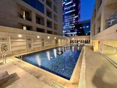 a swimming pool in the middle of a building at Luxury Apartments - Damac Tower Amman in Amman