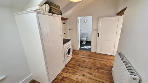 a laundry room with a washer and dryer in a house at Place Lodge in Porthscatho