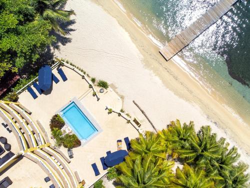 an overhead view of a beach with a swimming pool at Del Playa #1 Condo in West End