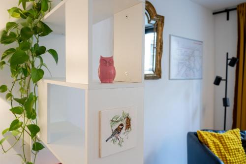 a living room with a red vase on the wall at Miniloft Pelgrim in Antwerp