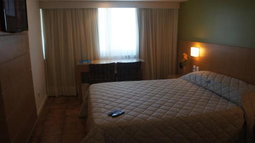 Un pat sau paturi într-o cameră la Hotel Barramares