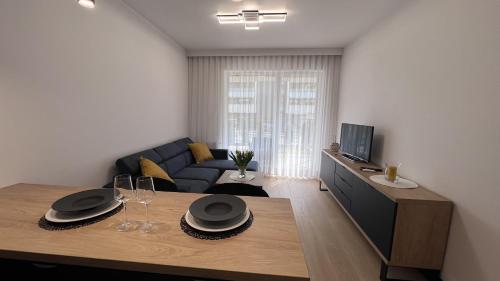 a living room with a table and a couch at Apartament Poleska in Częstochowa
