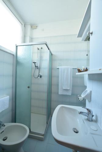 a bathroom with a glass shower and a sink at Hotel Bergamo Mare Mhotelsgroup in San Bartolomeo al Mare