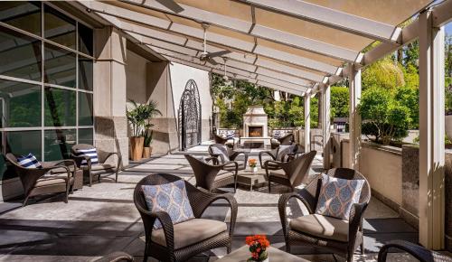 an outdoor patio with chairs and a fireplace at Hyatt Regency Sacramento in Sacramento