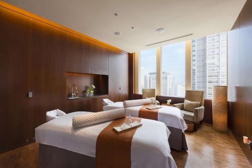 a hotel room with two beds and a chair at Hyatt Regency Tokyo in Tokyo