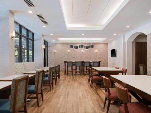 a dining room with wooden tables and chairs at Hampton Inn Deerfield Beach in Deerfield Beach