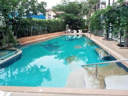 a large swimming pool with blue water at Condo Joe in Central Hua Hin in Hua Hin