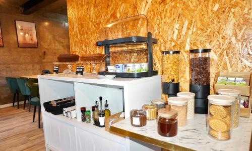 a counter with food items on it in a room at Lux'Otel City Lodge in Barcelos