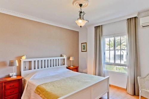 a bedroom with a large white bed and a window at Toboso 1 in Nerja