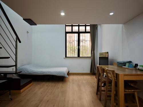 a room with a table and a bed and a dining room at iNestin Shanghai Apt Hongfeng Road in Shanghai