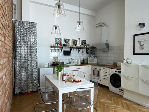 a kitchen with a white table and chairs at NICE "TRABI" APARTMENT IN THE CITY in Budapest