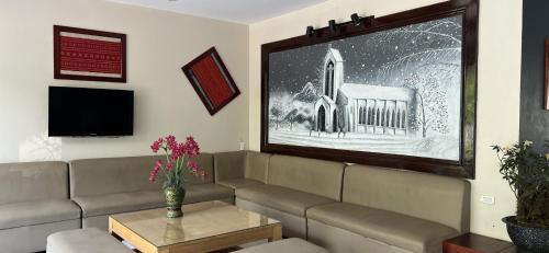 a living room with a couch and a tv at Sunshineview Sapa Hotel in Sapa