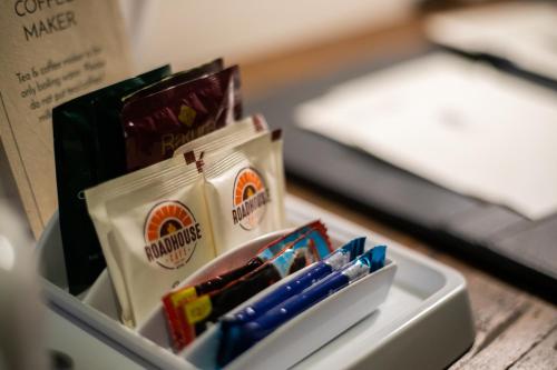 a box ofcolored pens andsharpening needles with a bed at Hotel Roadhouse, Thamel, Kathmandu- Contemporary Boutique in Kathmandu