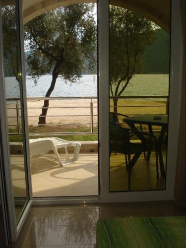 an open door to a patio with a table and chairs at Apartments Villa Danilovic in Herceg-Novi