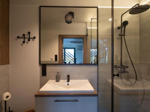 a bathroom with a sink and a shower at Rodzone Dolina 