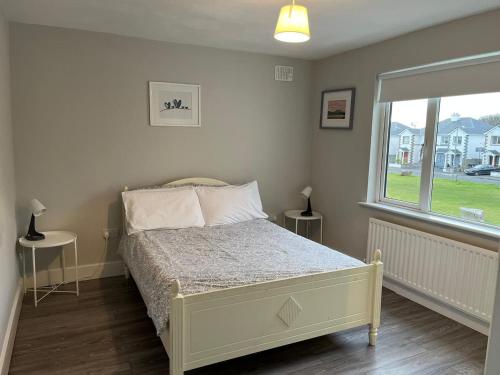 a bedroom with a bed and a window at Bay Area House, Spiddal in Spiddal