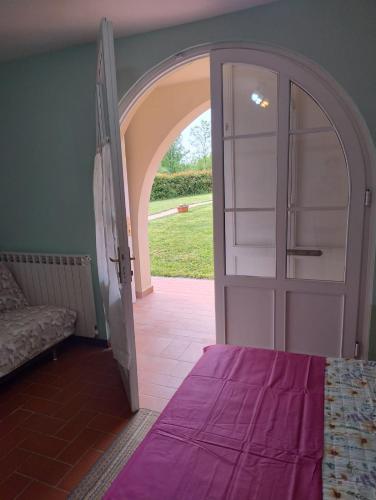 a room with an open door to a room with a bed at Casa Claudia in Capannori
