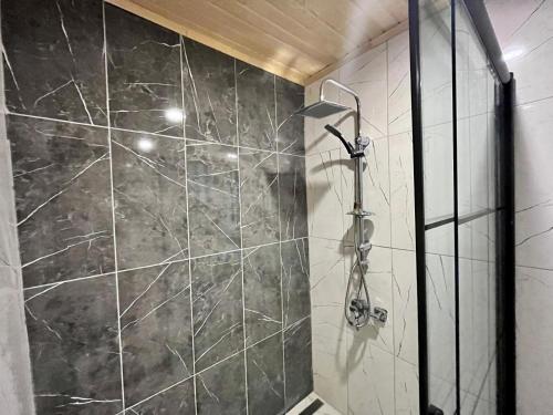a bathroom with a shower with black marble at CASABA OTELS 