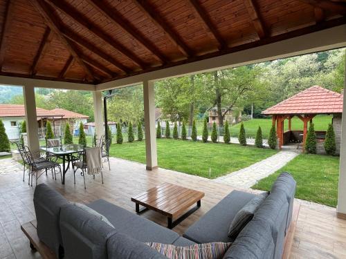 a living room with a couch and a table at Vip kuca Banja Vrujci in Popadić