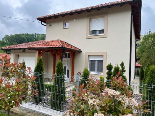 a house with a fence in front of it at Vip kuca Banja Vrujci in Popadić