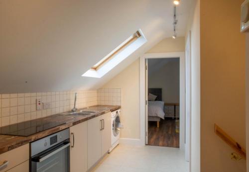 a kitchen with a sink and a counter top at Sruthan Pier House in Carraroe