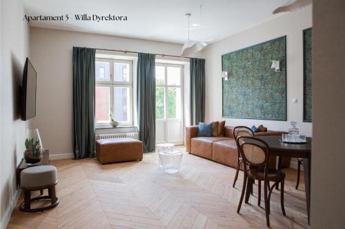 a living room with a couch and a table at Browar Hevelius Apartments by Grand Apartments in Gdańsk