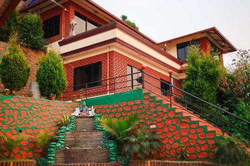 a house with a staircase in front of it at Doleshwor Village Resort & Farm House in Bhaktapur