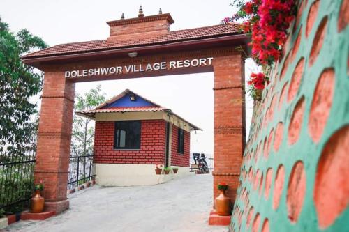 a building with a sign that reads dallas survivor villagelake resort at Doleshwor Village Resort & Farm House in Bhaktapur