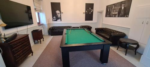 a living room with a pool table and chairs at Willa Bimbrówka in Wisła